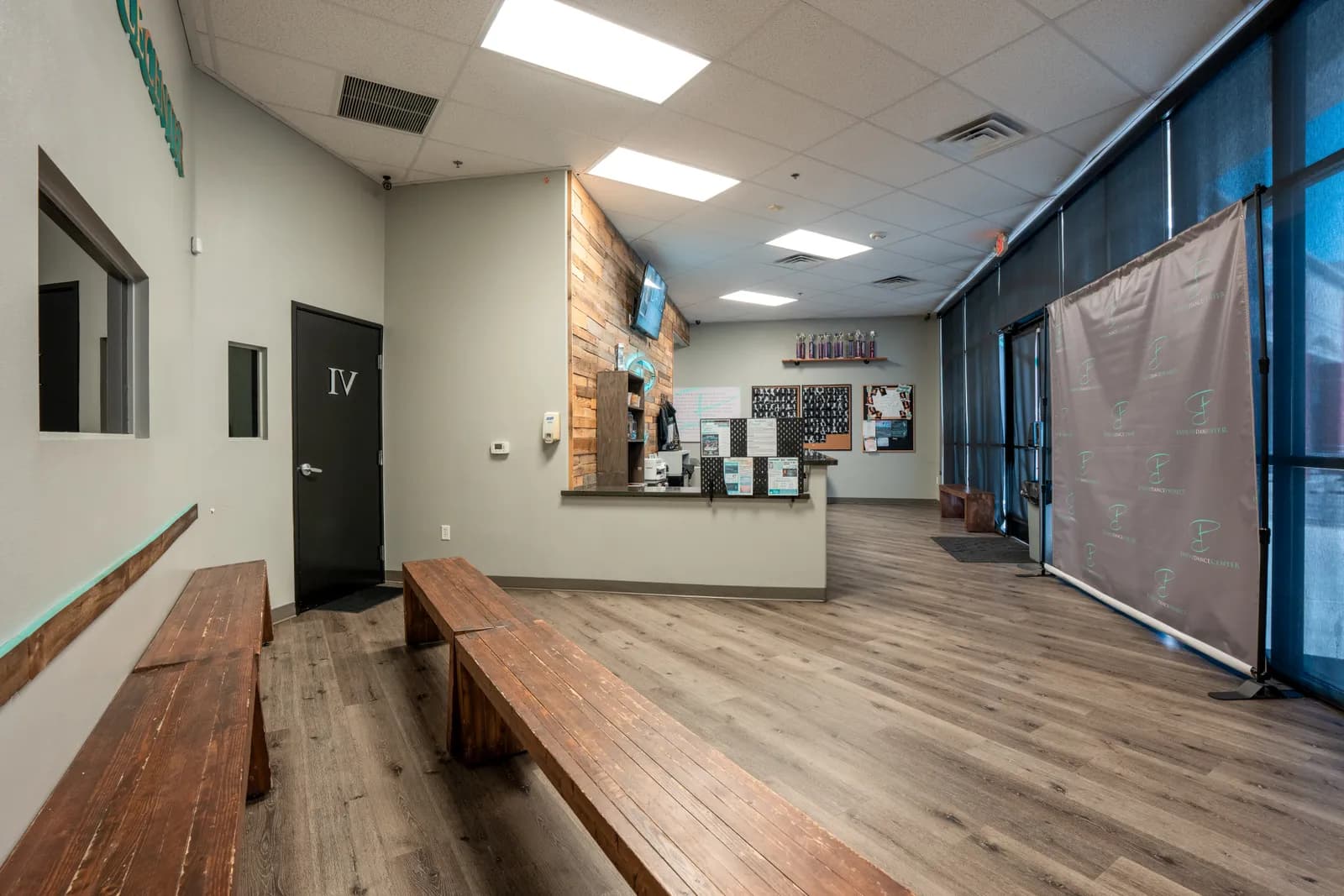 Hallway and waiting area at Evolve Dance Center with reclaimed wood benches