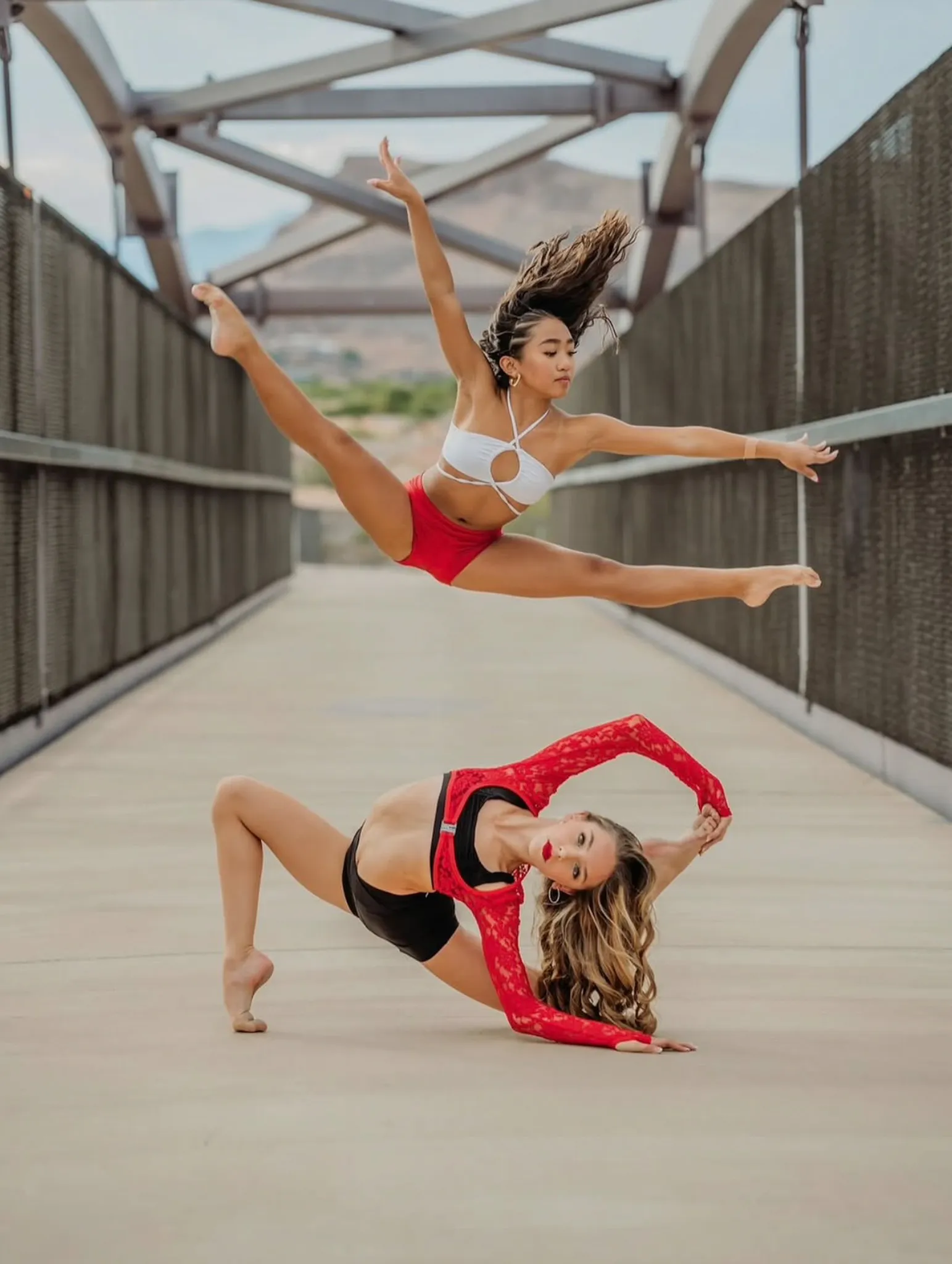 Evolve dancer in red posing on a bridge